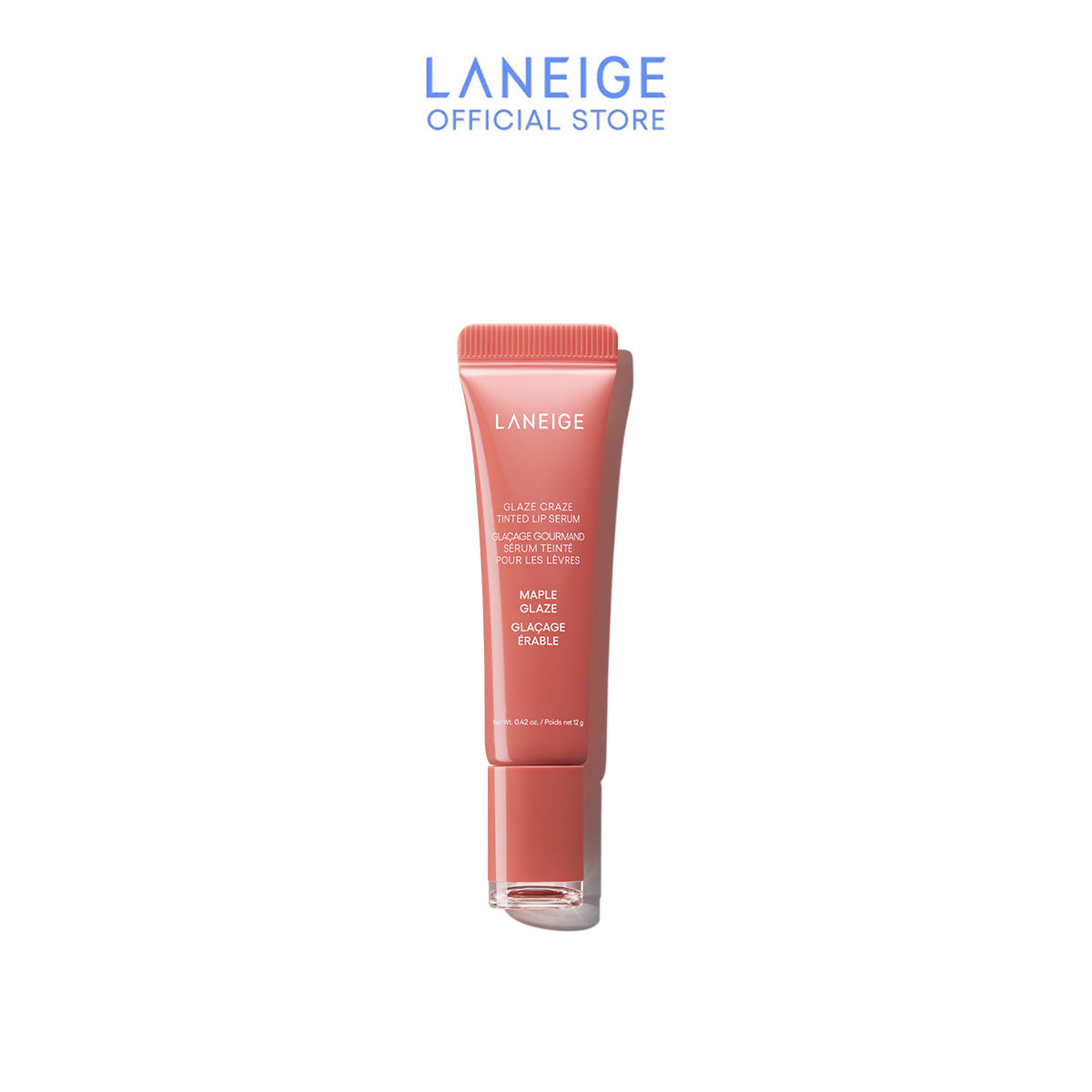 A tube of Laneige's Glaze Craze Tinted Lip Serum in Maple Glaze stands upright, showcasing its coral-toned hue and sleek design, promising a radiant, high-shine finish for lips.
