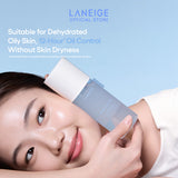 A woman rests her head gently on her hand, smiling softly while holding a bottle of Laneige Cream Skin Zincpeptide 2-in-1 Toner & Gel Moisturizer, showcasing its lightweight, hydrating formula for 12-hour oil control without dryness.