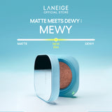 A pale blue Laneige Neo Cushion Mewy refill case, partially open to reveal a brown cushion puff, showcases the product's matte-yet-dewy finish, representing the "new era" in foundation technology.